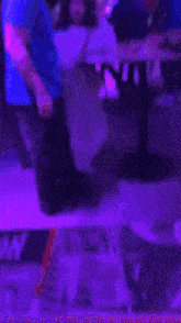a man in a blue shirt stands next to a woman at a table with a sign on the floor that says la mision