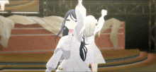 two anime girls are standing on a stage with their arms up
