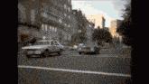 a white car with the number 1 on the side is driving down the street