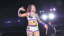 a woman in a wrestling ring with the word aem on her arm