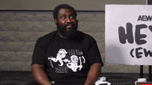 a man with a beard wears a black shirt that says lazy cat crazy