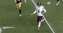a football player with the number 8 on his jersey runs with the ball