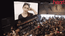 a large group of people are gathered in front of a large screen that says heart on it