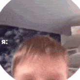 a close up of a child 's face in a circle with the word я written on it