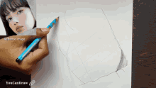 a person is drawing a picture of a woman with a blue pencil on a piece of paper