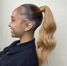 a woman is wearing a ponytail and earrings