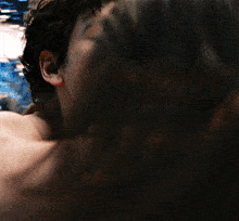 a close up of a man kissing a woman