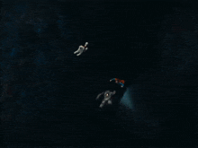 a man in a superman cape is fighting another man in a batman suit
