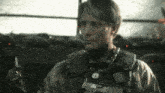 a man in a military uniform holds a lighter and a gun