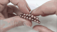 a close up of a person holding a bunch of beads