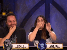 nott goblin rogue and jester tieflling cleric are sitting next to each other