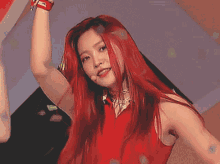 a woman with red hair wearing a red dress