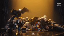 a group of people are laying on the floor in front of a hbo max ad