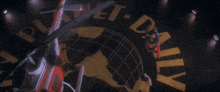 a man in a superman costume is flying in front of a planet a logo