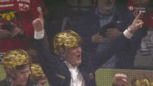 a man wearing a gold helmet with the name maiden on his jacket
