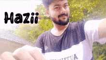 a man with a beard is wearing a shirt that says ' haziii ' on it