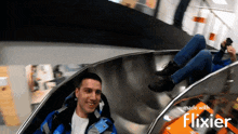 a man and a woman are riding a slide made with flixier