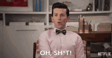 a man in a pink shirt and bow tie is saying oh sh * t