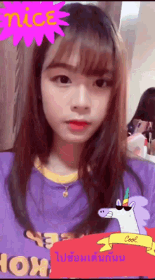 a girl is wearing a purple shirt with a unicorn sticker on it .