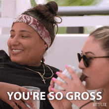 two women sitting next to each other with the words you 're so gross in the corner