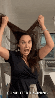 a woman is making a funny face while holding her hair and the words computer training are visible behind her