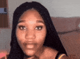 a woman with braids looks at the camera with her mouth open