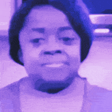 a close up of a woman 's face in a purple light