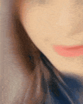 a close up of a woman 's face with red lipstick on her lips