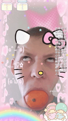 a man with an orange in his mouth with a hello kitty face on it