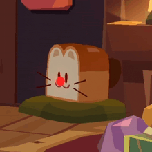 a piece of bread that looks like a cat has a red nose