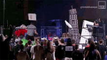 a crowd of people watching a wrestling match with a sign that says totaldivaseps on it