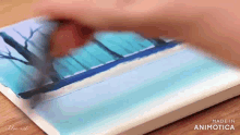 a person is painting a picture with the words made in animatica visible