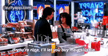 a man and a woman are standing in a store and the woman is saying if you 're nice