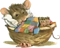 a mouse is laying in a basket with a patchwork blanket on