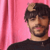 a man with a beard has a hand on his head