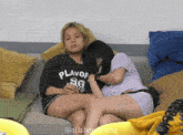 two women sitting on a couch with one wearing a shirt that says " flavor "