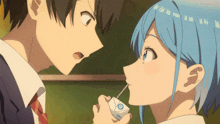 a boy and a girl are looking at each other and the girl is holding a carton of milk with a straw