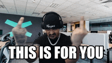 a man wearing headphones giving the middle finger and the words this is for you
