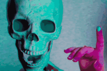 a painting of a skull with a pink hand pointing