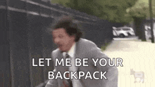 a man in a suit and tie is running down a street and saying let me be your backpack .