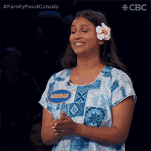 a woman with a flower in her hair and a name tag that says nabibah