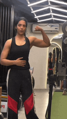 a woman is flexing her muscles in front of a mirror that says 19