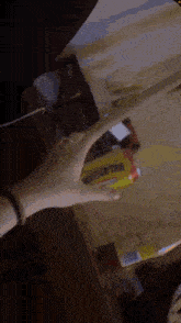 a person holding a bottle of iced tea in their hand