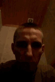 a man 's face is shown in a blurry photo with his eyes closed .