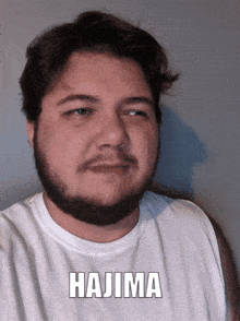 a man with a beard is wearing a white shirt with the name hajima on it