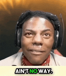 a man wearing headphones is making a funny face and the words ain 't no way are above him .