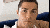 a close up of a man 's face while sitting on a couch .