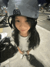 a little girl wearing a helmet that says ' sss ' on it