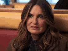 a close up of a woman making a funny face while sitting in a restaurant .