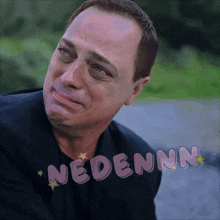 a man with a sad look on his face and the word nedenn on the bottom right